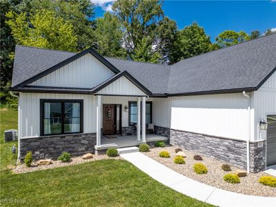 View of front of home featuring a front yard, a garage, and central AC unit | Image 3