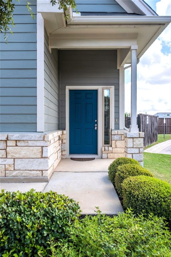 View of exterior entry with stone siding and a porch | Image 5