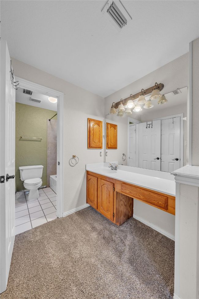 Full bath with vanity, carpet floors, and shower / bath combination | Image 26