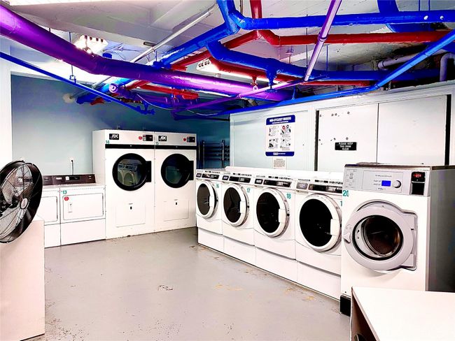 Shared laundry featuring washing machine and clothes dryer | Image 9