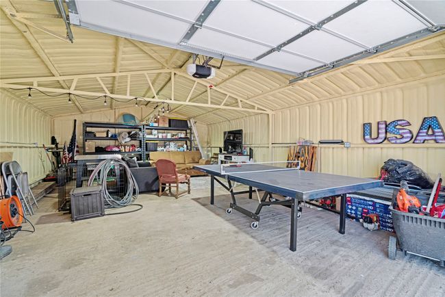 Garage featuring metal wall and a garage door opener | Image 18