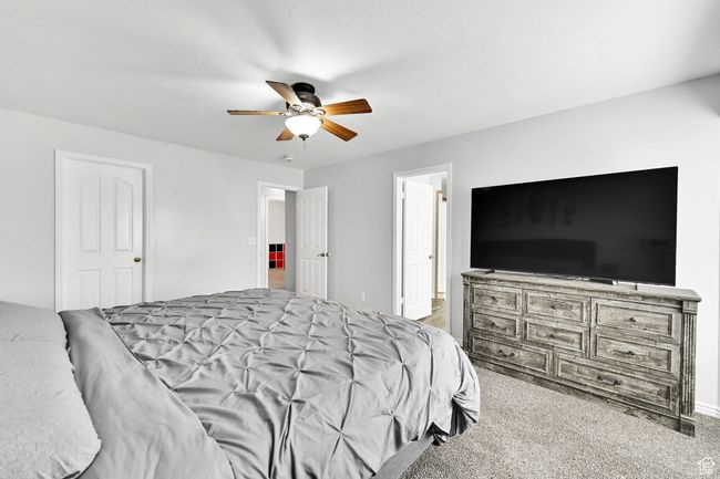 Carpeted bedroom with a ceiling fan | Image 17