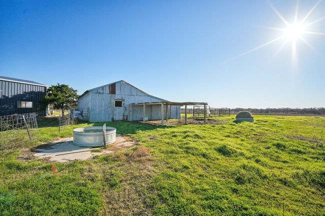 Back view of the barn with stock tank and hay. | Image 37