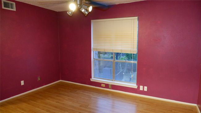 Empty room featuring hardwood / wood-style flooring, ceiling fan, and a textured ceiling | Image 19