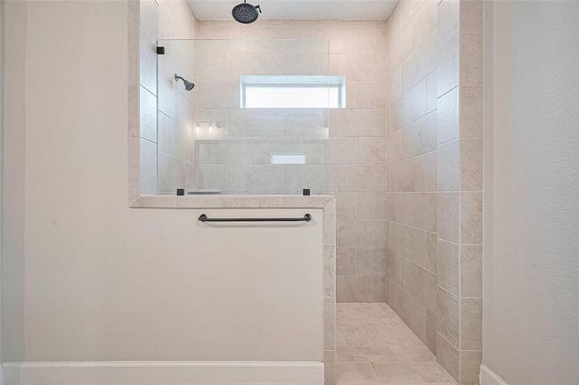 The walk-in shower with tile surround and rain showerhead offers a serene retreat, while the spacious layout connects seamlessly to the primary suite | Image 23