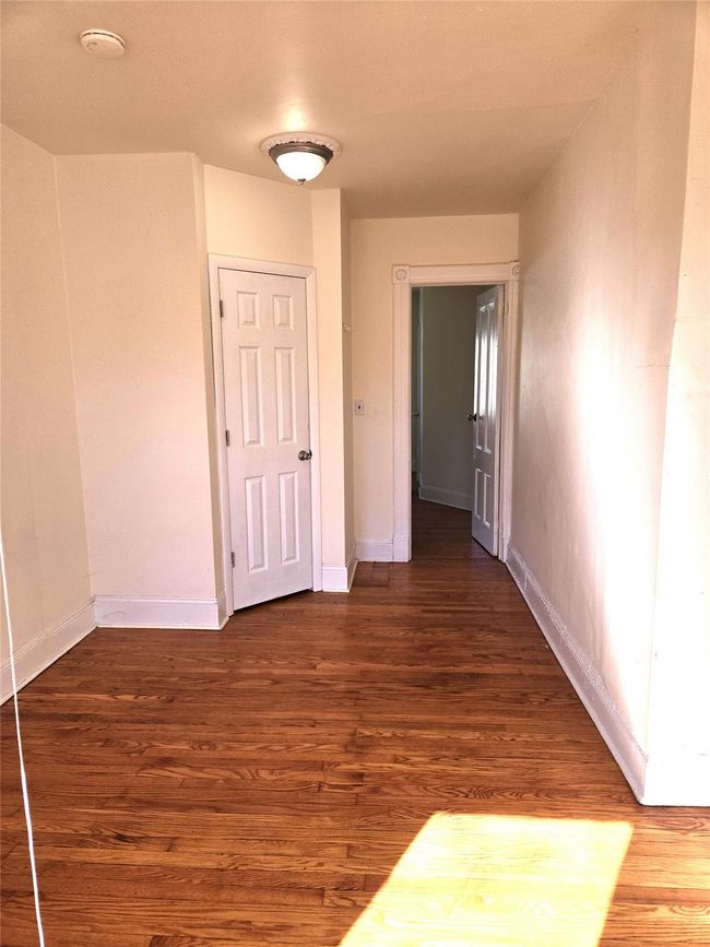 Hall featuring wood finished floors and baseboards | Image 16