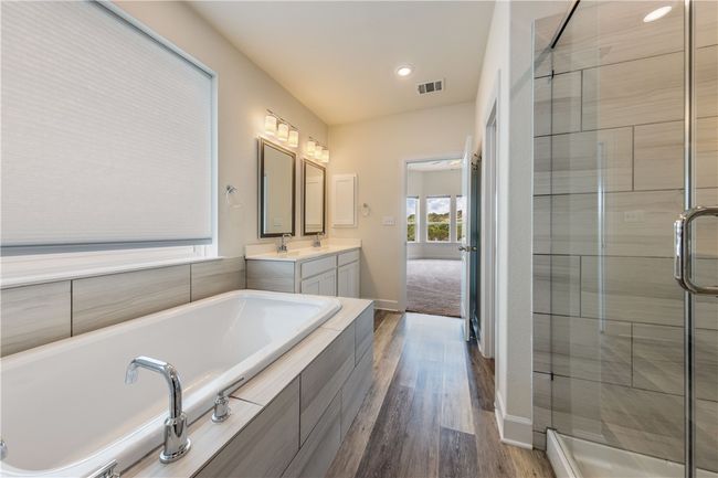Soaking tub with large picture window and plenty of natural light. | Image 12
