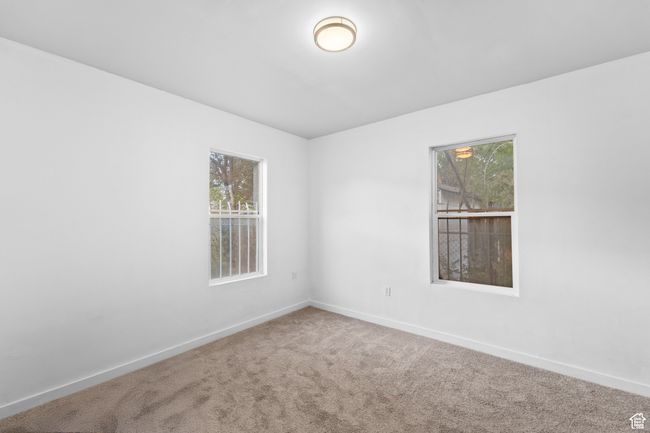Spare room with baseboards, carpet flooring, and a healthy amount of sunlight | Image 21