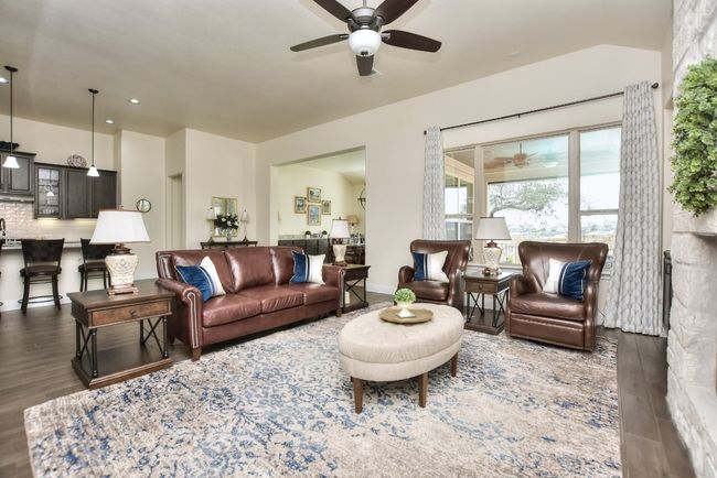 Living area with recessed lighting, baseboards, wood finished floors, and a ceiling fan | Image 11