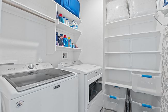 Washroom with laundry area and separate washer and dryer convey with home. | Image 25