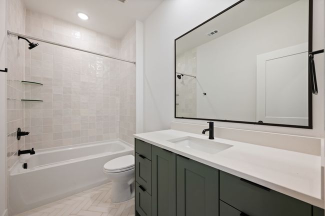 Beautiful and spacious, friends and family will love this main floor guest bath. | Image 8