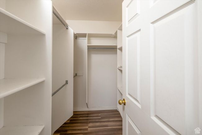 Primary bedroom Spacious closet featuring dark hardwood / wood-style floors | Image 20