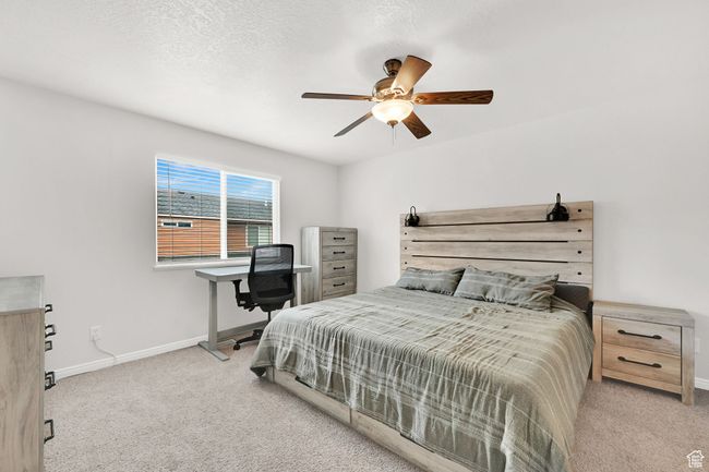 Bedroom with ceiling fan, a textured ceiling, baseboards, and carpet floors | Image 19