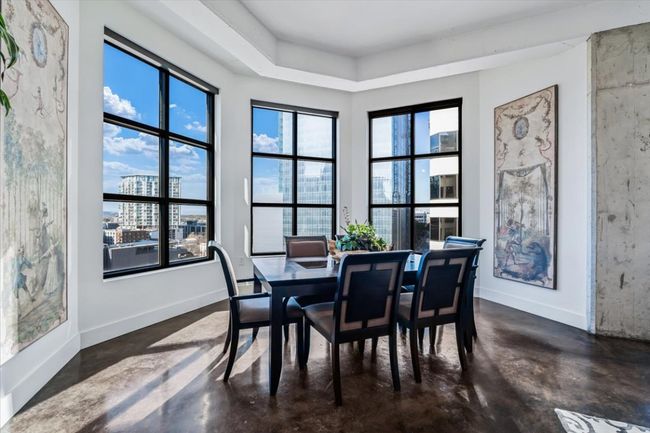 Dining space with stained concrete floors and bay windows overlooking the hill country and city | Image 14