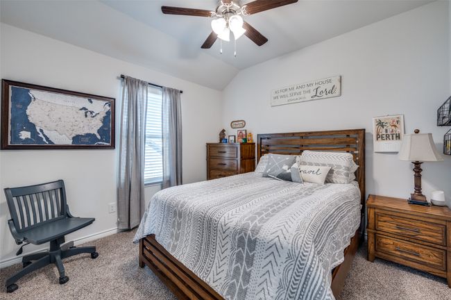 Bedroom with carpet floors, a ceiling fan, baseboards, and vaulted ceiling | Image 21