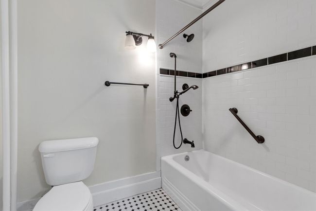 Full bath featuring toilet, tile patterned floors, and baseboards | Image 25