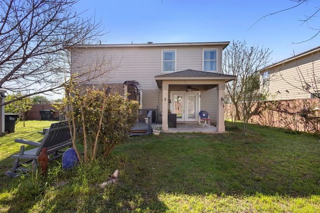 Rear view of property with french doors, a ceiling fan, a wooden deck, fence, and a yard | Image 32
