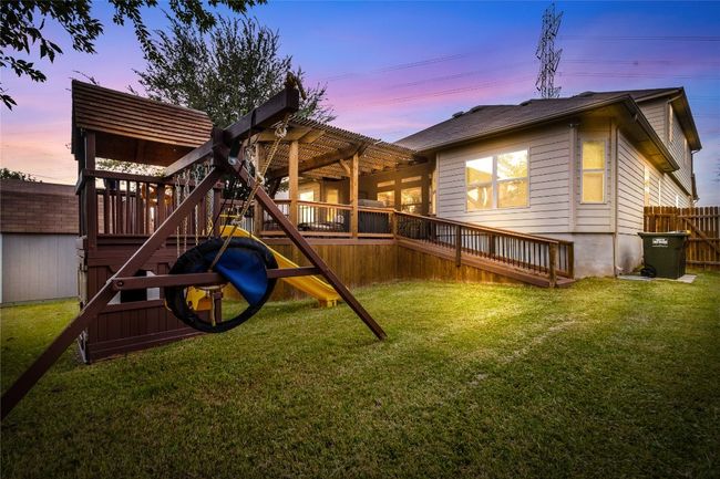 Outdoor structure at dusk with a fenced backyard and a storage shed | Image 19