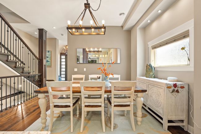 Dining room featuring a chandelier, stairway, wood finished floors, and recessed lighting | Image 8