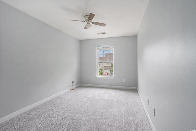 Empty room featuring carpet flooring and ceiling fan | Image 13