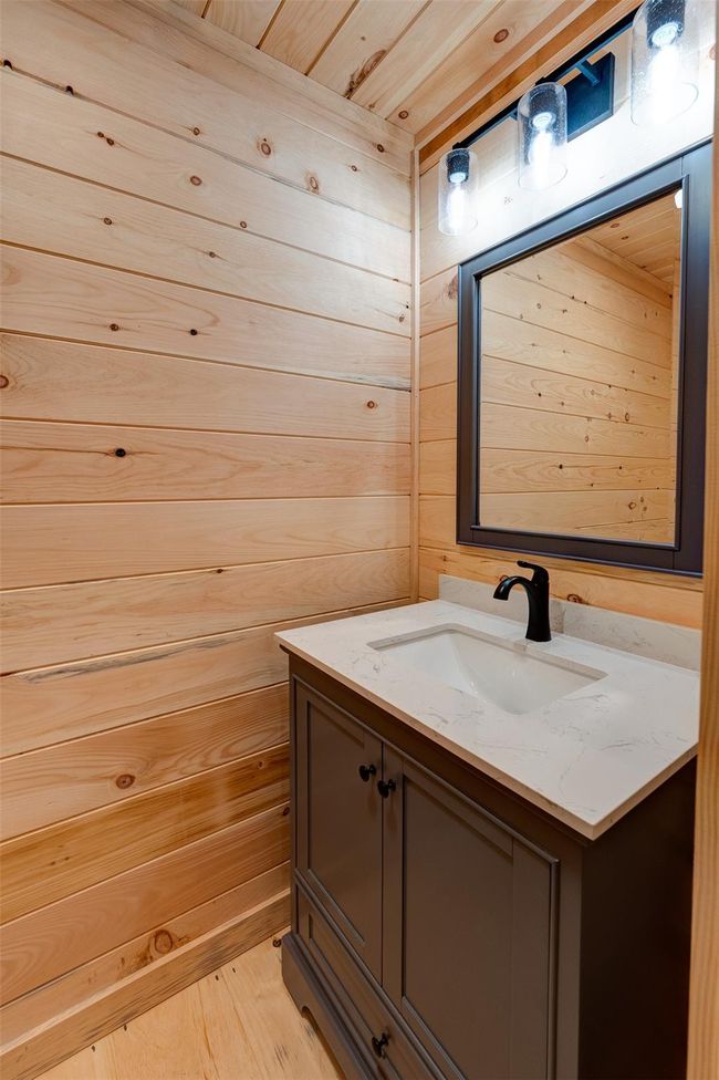 Bathroom featuring vanity, wooden walls, and wood finished floors | Image 26