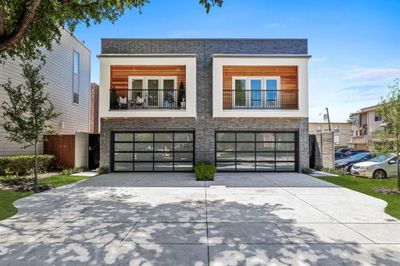 View of front of property with a balcony and a garage | Image 1