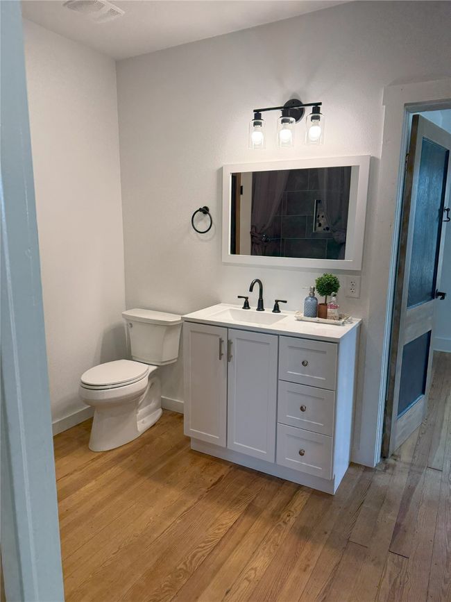 Bathroom with wood finished floors and vanity | Image 20