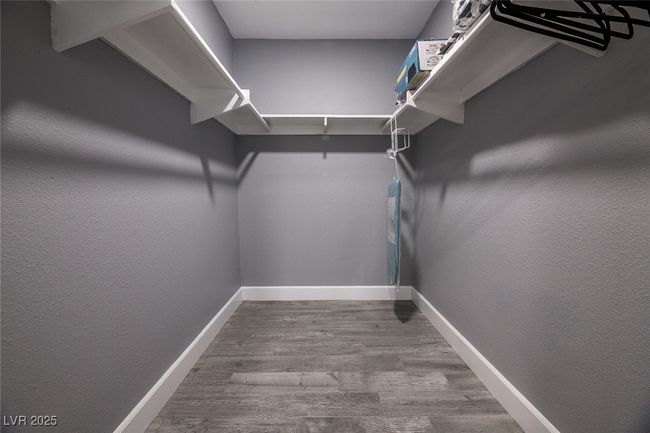Walk in closet featuring wood finished floors | Image 45