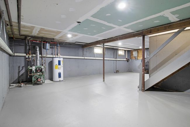 Basement featuring electric water heater and a heating unit | Image 31