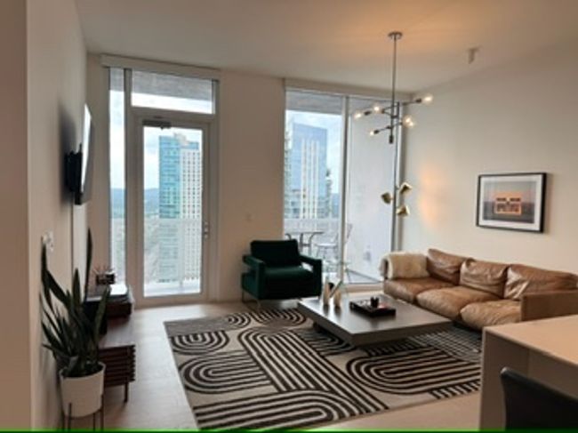 Living area with a chandelier | Image 17