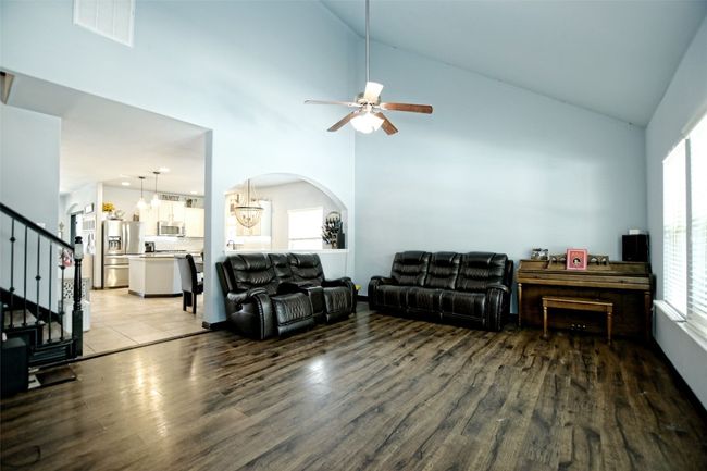 Family area open to the kitchen/dining and windows with views of the pool and yard | Image 13