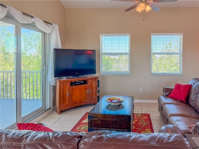 Living area featuring plenty of natural light, a ceiling fan, and light tile patterned flooring | Image 18