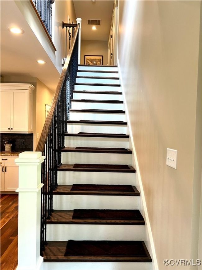 Stairs featuring wood finished floors, a towering ceiling, and recessed lighting | Image 16