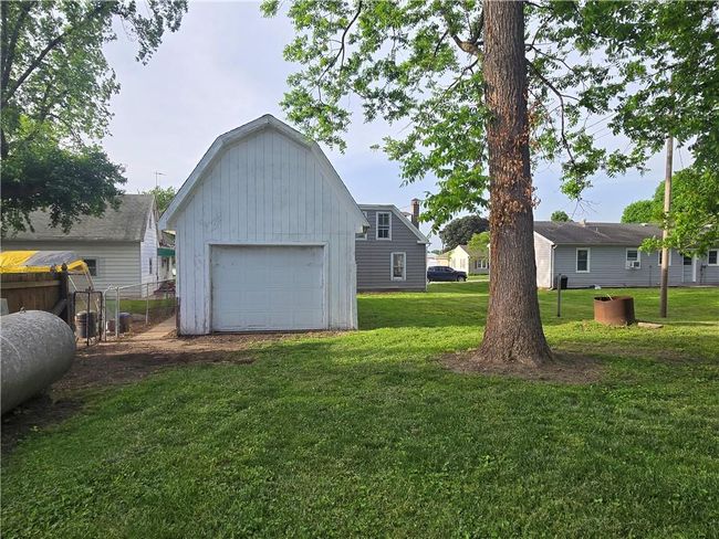 View of yard featuring a garage and an outbuilding | Image 6