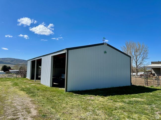 View of outdoor structure featuring a mountain view and a yard | Image 7