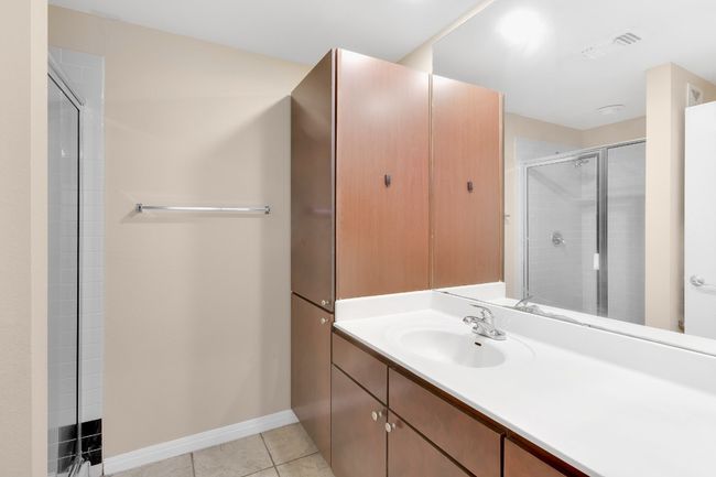 Full bath featuring a shower area, vanity, tile patterned flooring, and baseboards. All new paint. | Image 14