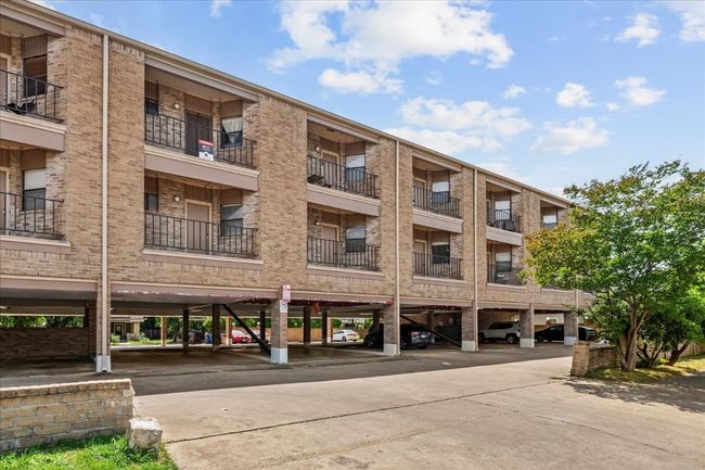 View of apartment building / complex with covered parking | Image 38