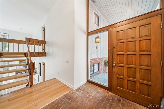 Entryway with baseboards, stairs, and brick floor | Image 30
