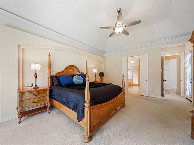 Spacious master bedroom featuring abundant natural light and soaring ceilings. | Image 25