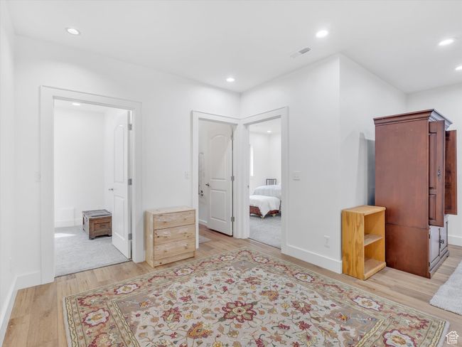 Unfurnished bedroom featuring baseboards, light wood-style flooring, visible vents, and recessed lighting | Image 30
