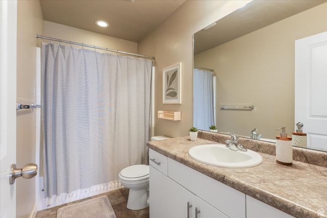 Bathroom featuring tile patterned flooring, toilet, vanity, and recessed lighting | Image 8