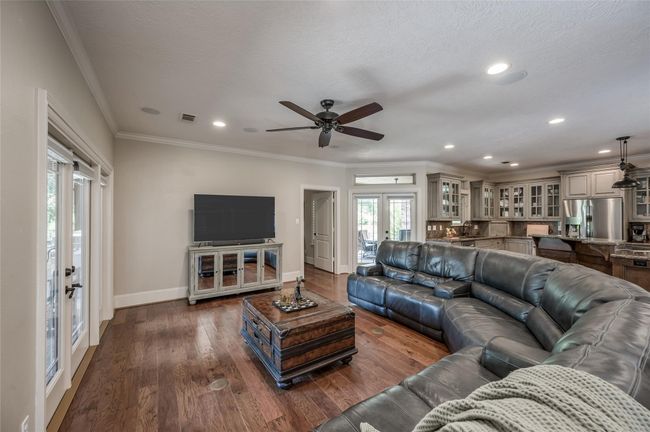 Enjoy abundant natural light through transom windows above the winter patio and kitchen sink. The primary bedroom is conveniently located near the main living areas. | Image 10