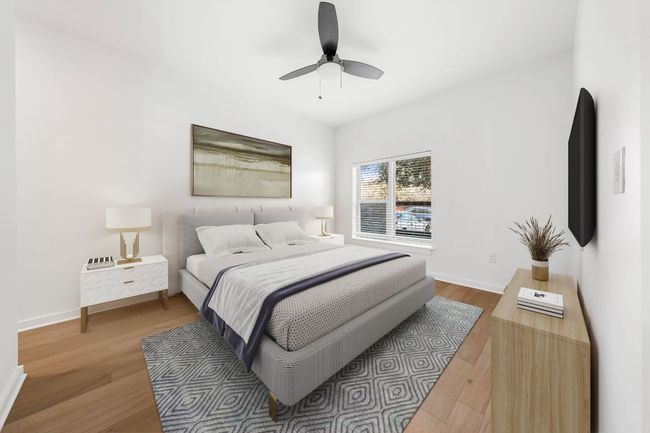 Bedroom with ceiling fan, baseboards, and wood finished floors | Image 6