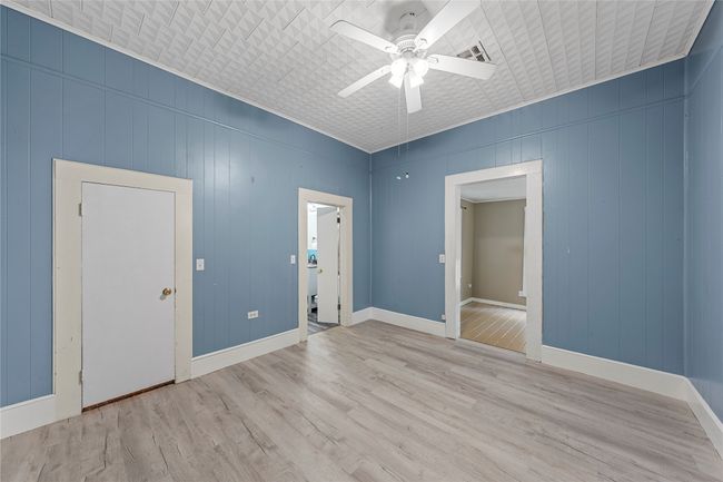 Empty room featuring ceiling fan and light wood finished floors | Image 18