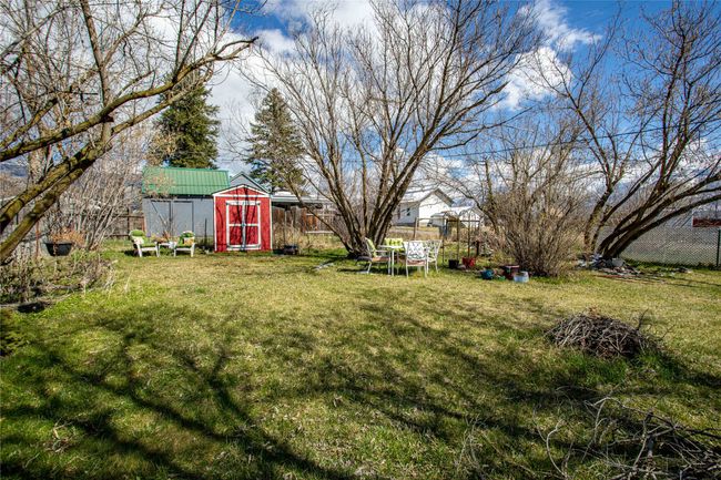 View of yard featuring a shed, fence, and an outdoor structure | Image 21