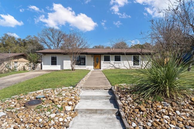 Ranch-style home featuring brick siding and a front yard | Image 4