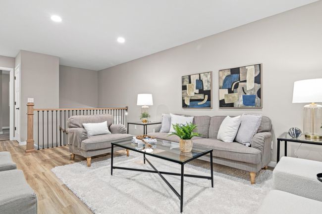 Just off the living room, the staircase has been beautifully updated with stylish new posts and balusters, enhancing the home’s overall aesthetic. | Image 5