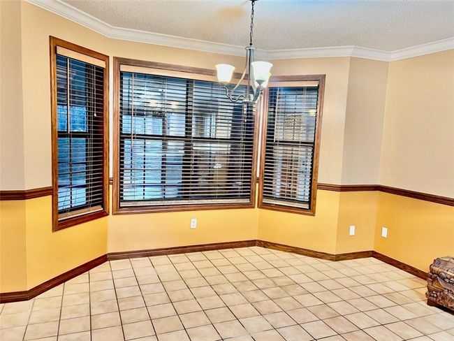 Breakfast nook with view of glassed in porch | Image 20