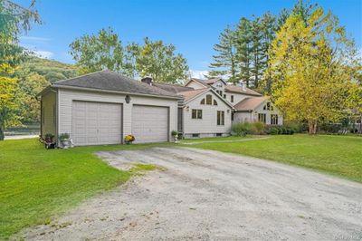 View of front of home with a front yard and a garage | Image 2