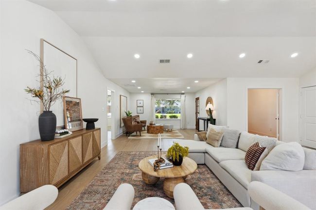 From this angle, the living space reveals the door to the dedicated office. | Image 7